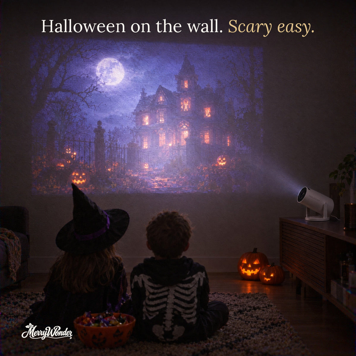 Halloween haunted house scene projected on the wall for two kids in costume