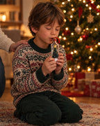 A child recording a message into the ornament