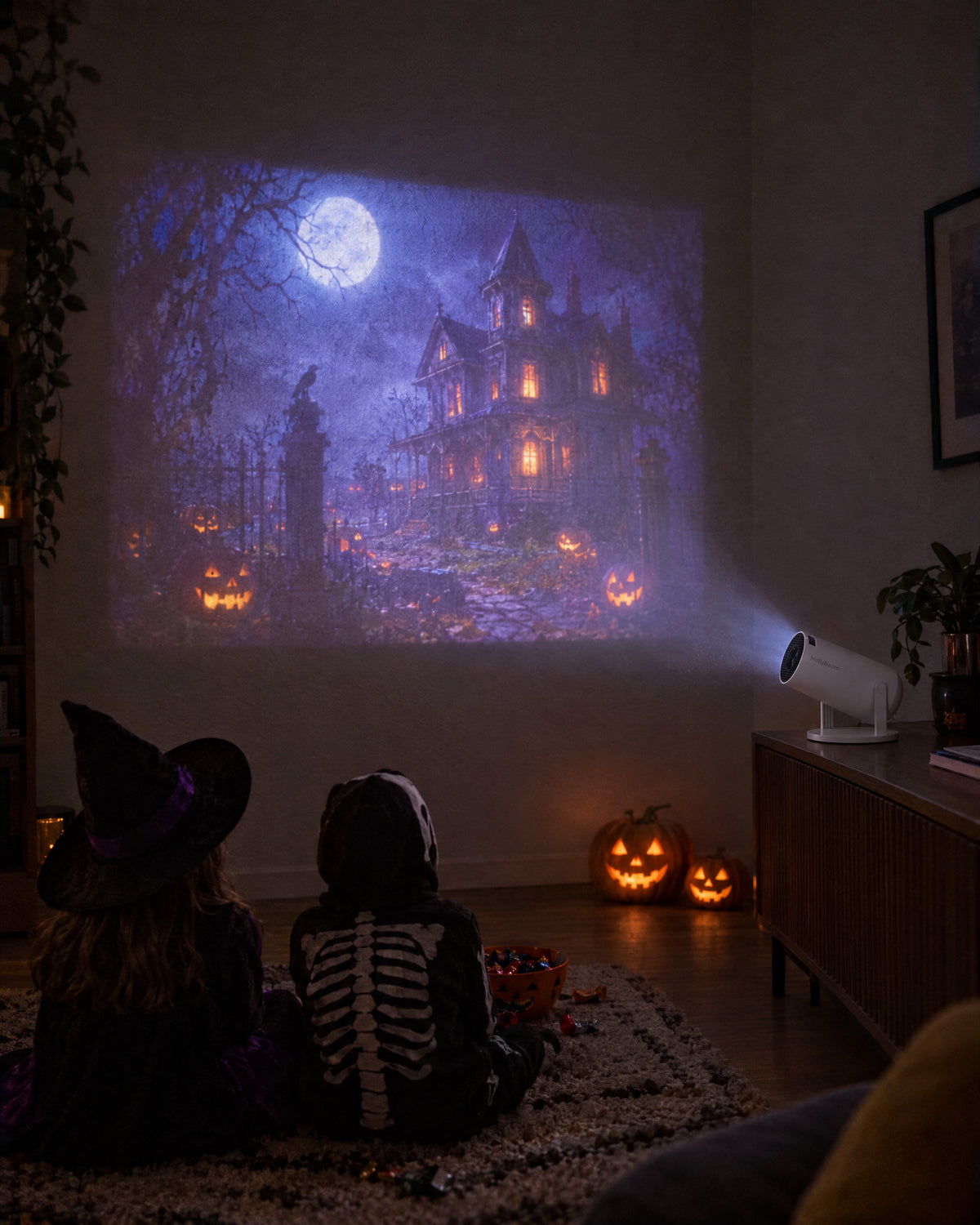 Halloween scene projected on the wall for two kids in costume